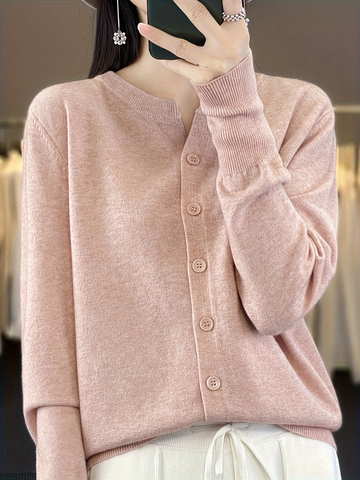 Front view of a model wearing the pink buttoned knit cardigan with ribbed cuffs and a round neck