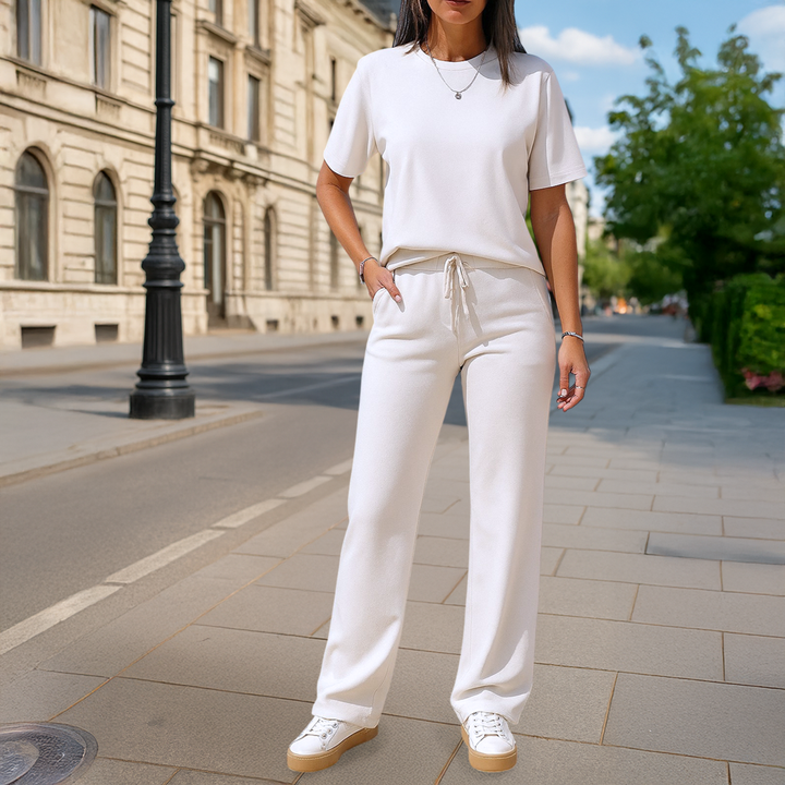 Front view of a woman wearing a cream casual two-piece set with a t-shirt and wide-leg pants