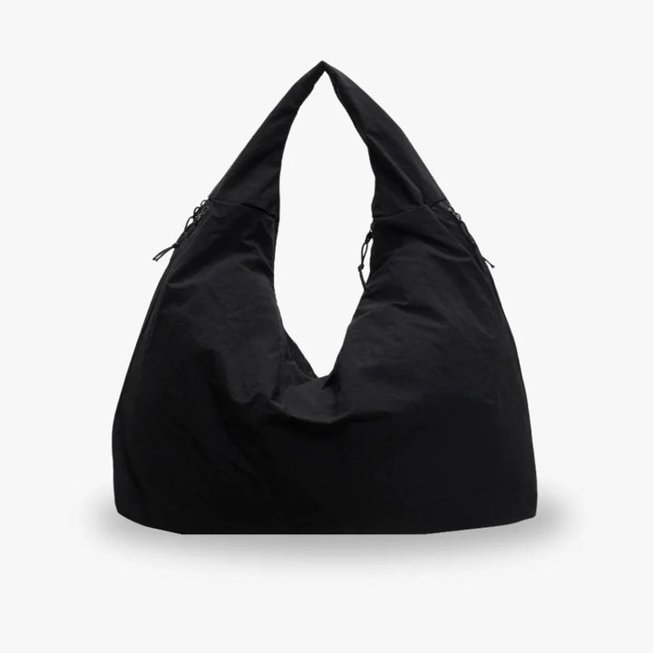Front view of a black recycled nylon hobo bag with a spacious, triangular design and drawstring details