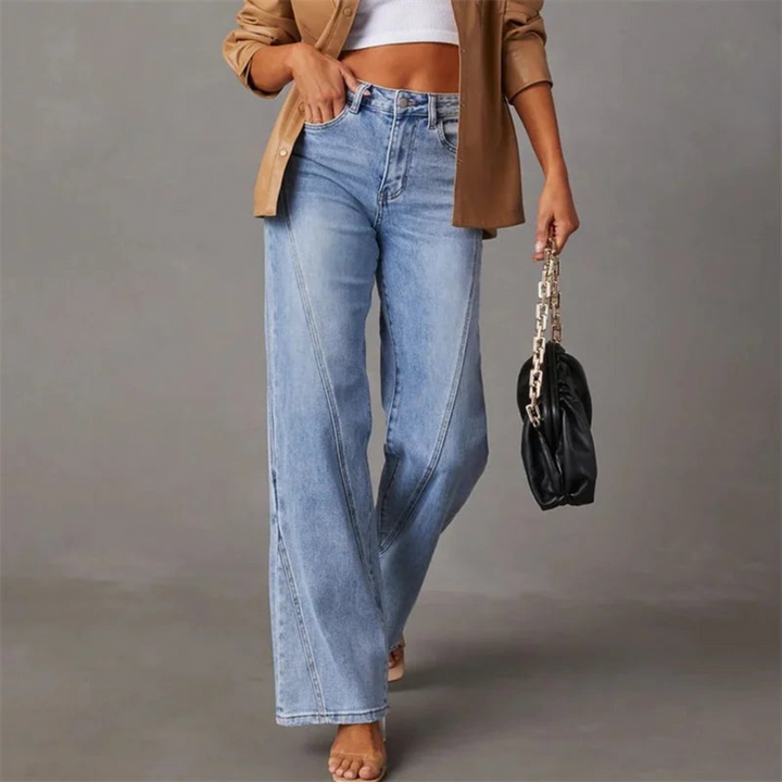 Light wash blue wide leg jeans with diagonal seams and a brown jacket