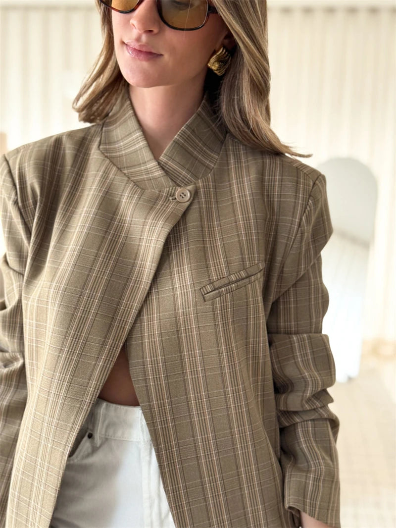 Three quarter view of a khaki plaid check blazer jacket with a mandarin collar and single button closure