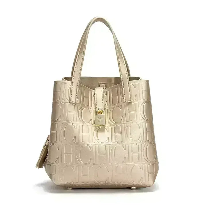 Front view of a gold Kara Classic Large Bucket Handbag with embossed &