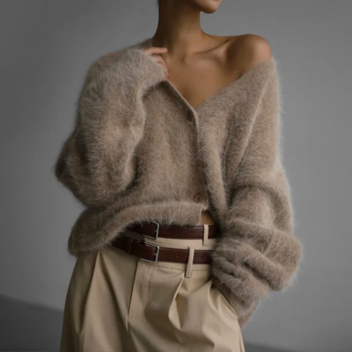 Front view of a model wearing an oversized V-neck knit cardigan in a fluffy beige wool blend, with two brown belts