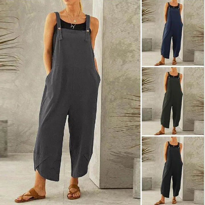 Front view of a model wearing the dark grey Isla oversized cotton-linen summer overalls with a black top