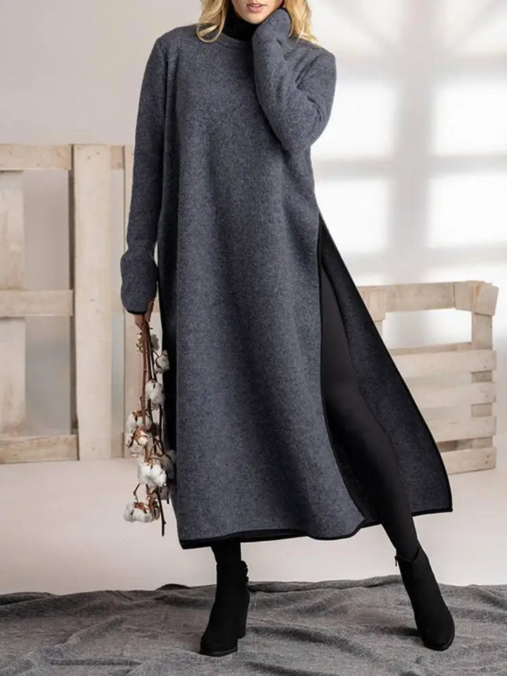 Front view, model wearing a grey plus size vintage split midi sweatshirt dress with black leggings and boots