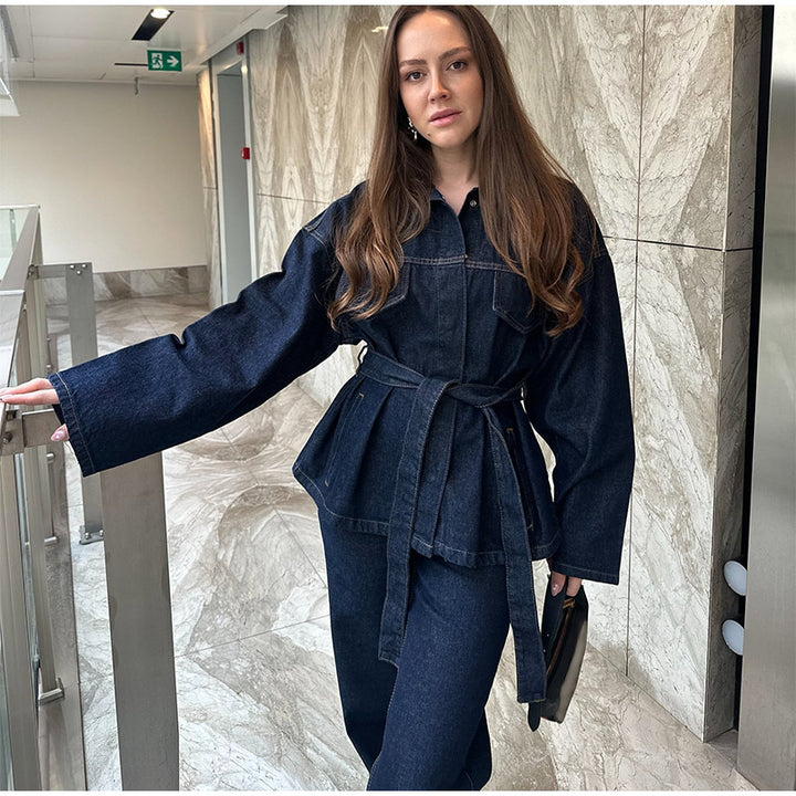 Front view, worn by model, of the vintage spliced denim trousers and belted jacket set