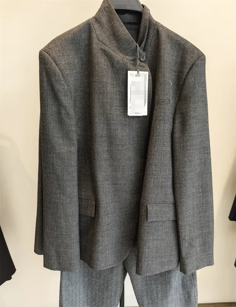 Front view of a charcoal grey mandarin collar jacket with a single button closure and front patch pockets