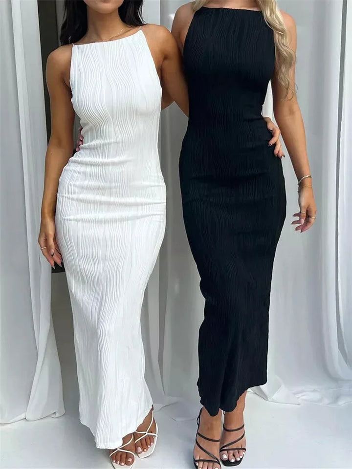 Front view of two women wearing ankle length ruched evening dresses, one white and one black