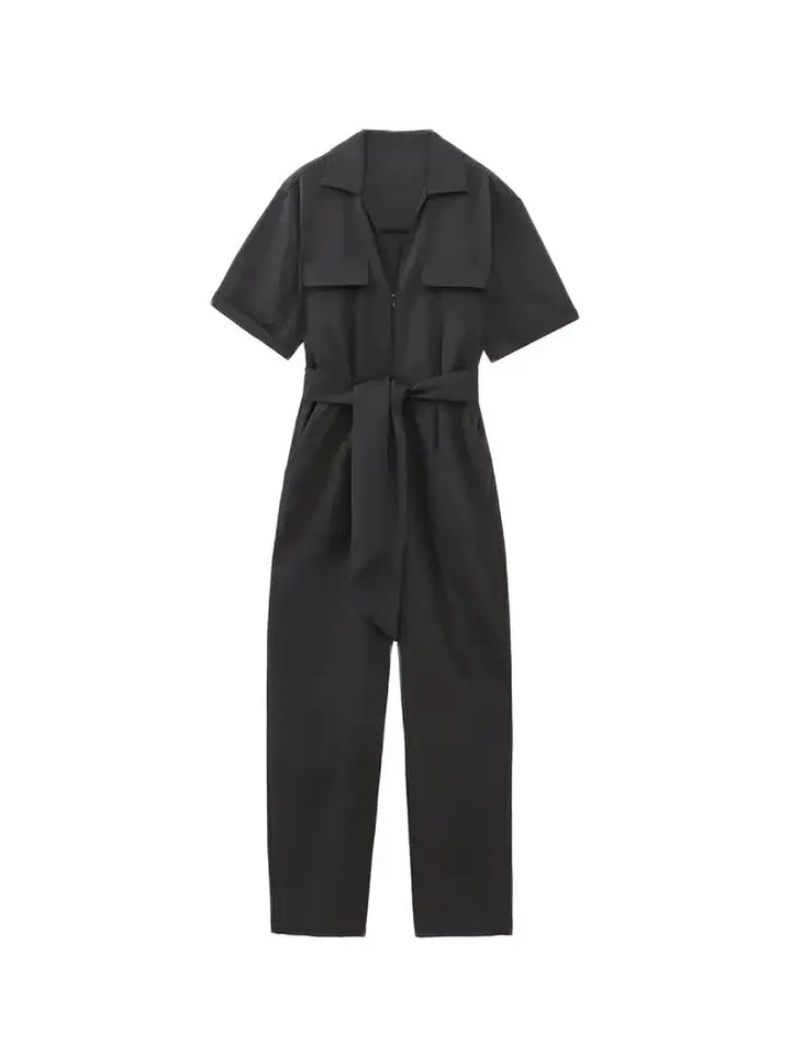 Front view of a black belted short sleeve zipper playsuit with a straight fit, on a white background