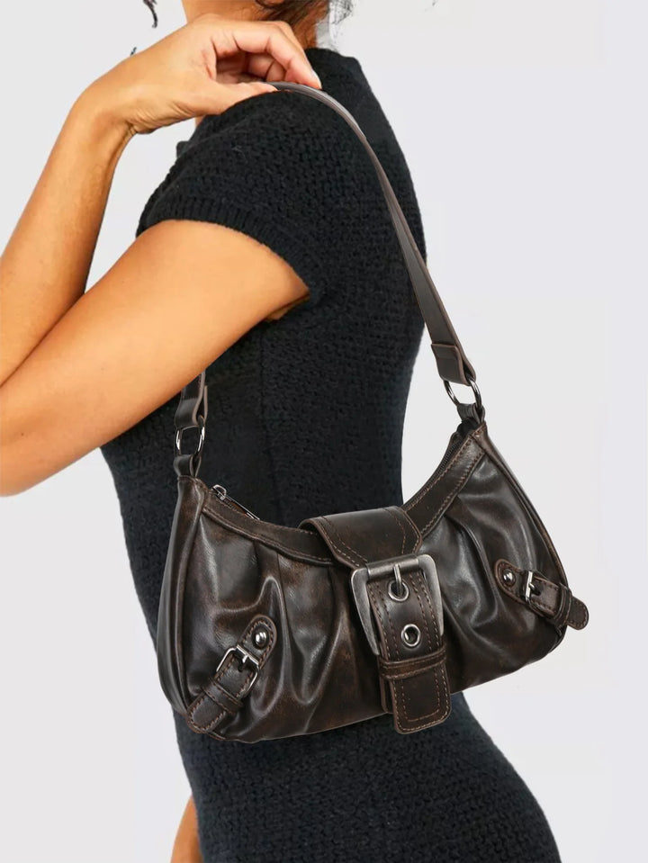 Nola Retro Y2K Shoulder Bag worn by model, a dark brown faux leather handbag with buckle details