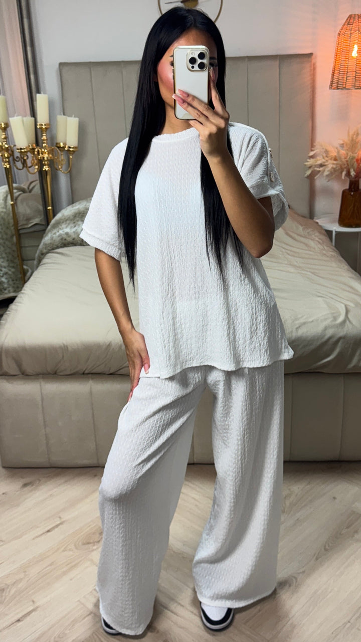 Oversized Viscose Set worn by model, front view. White textured top with golden buttons on sleeves and matching wide leg