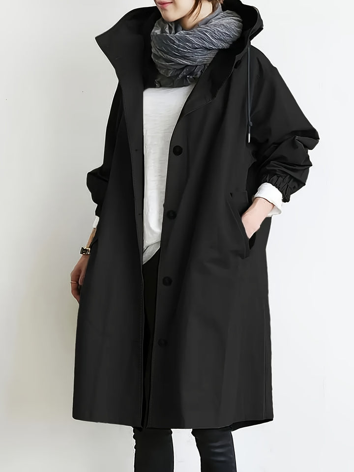Front view, model wearing a black elegant woven trench coat over a white top with a grey scarf and black pants