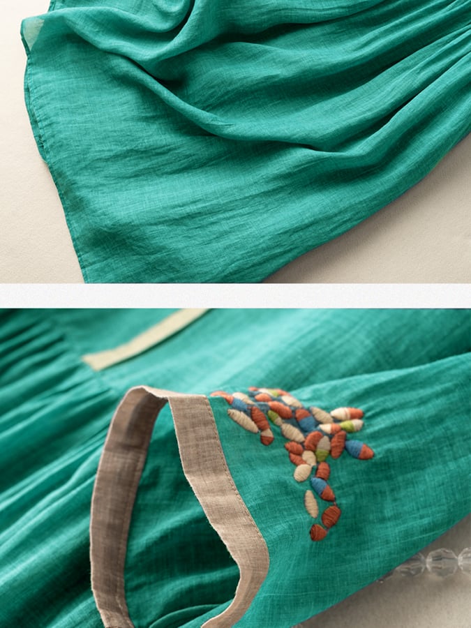 Close up detail of the green cotton dress fabric and colourful ethnic embroidery on the sleeve cuff
