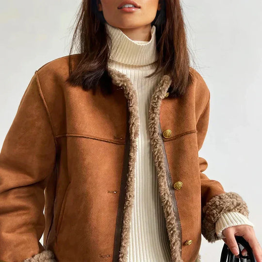 Tan brown sheepskin buttoned jacket, close up of the shearling trim