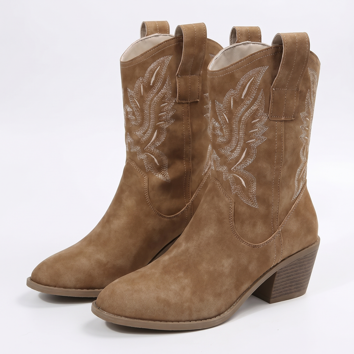 Pair of tan western ankle boots, three quarter view, showing embroidered shafts and pointed toes