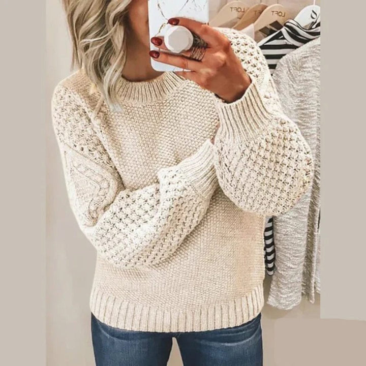 Front view of a woman wearing the Aria soft cotton sweater with textured sleeves and ribbed cuffs