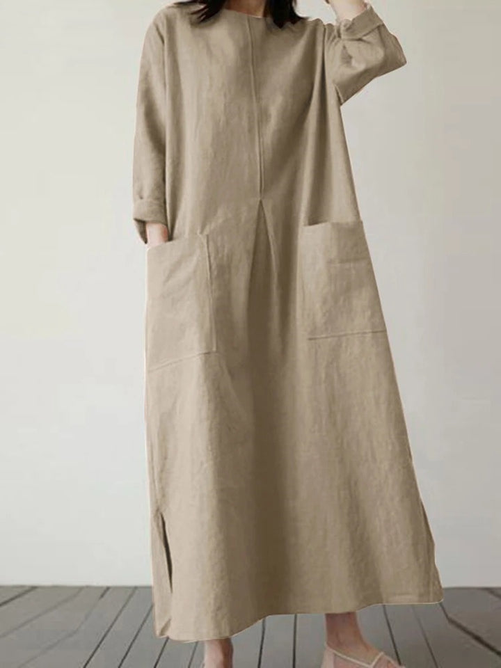 Front view of a model wearing the Georgia summer vintage baggy loose casual dress in a light tan with large pockets