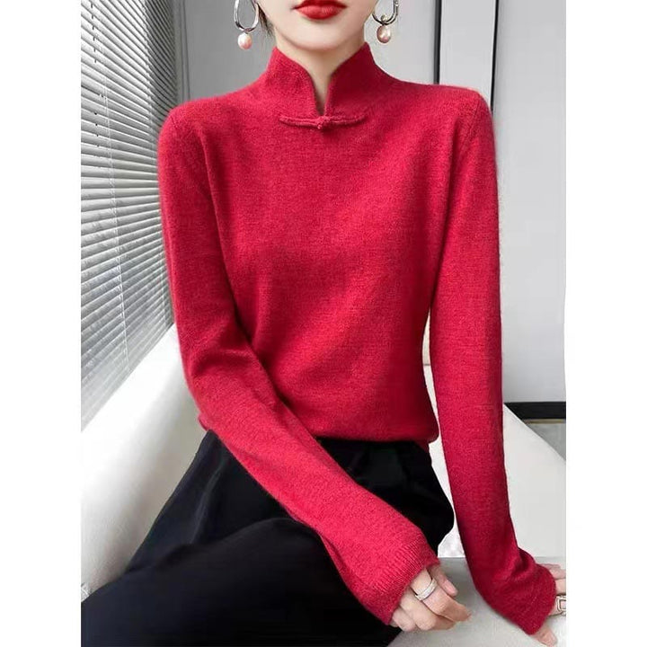 Front view of a model wearing a slim fit red wool mandarin collar sweater with a decorative frog closure