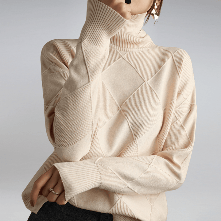 Front view of a model wearing a cream check turtleneck knit sweater with textured diamond patterns