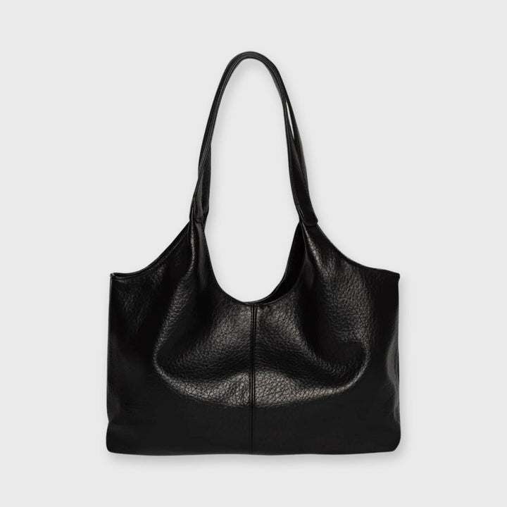 Front view of the Hannah Tote, a black leather shoulder bag with a single strap and textured finish